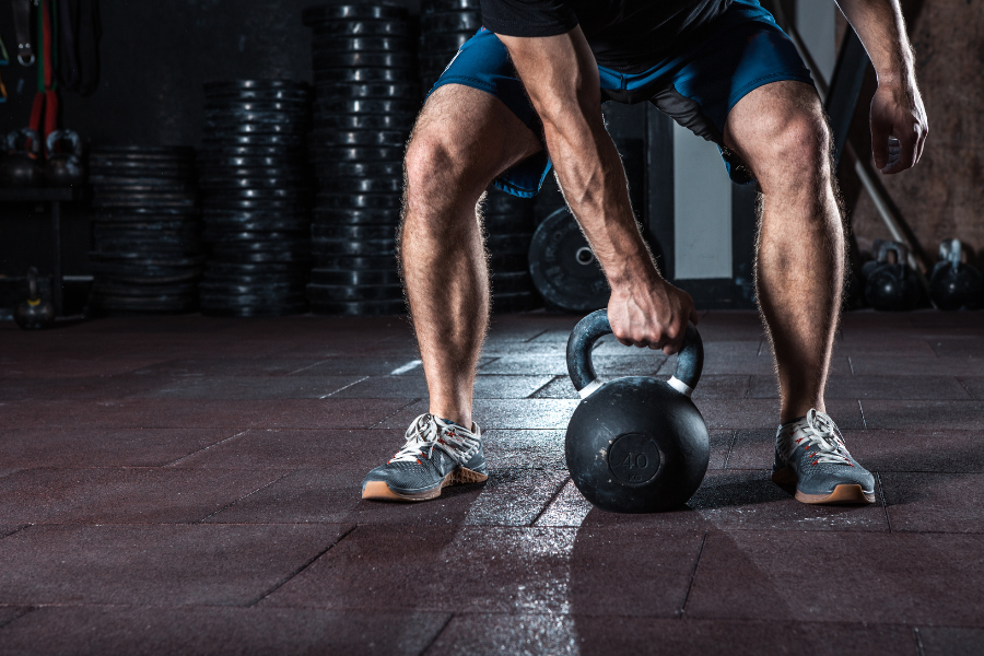 MAN REACHING FOR KETTLEBELL