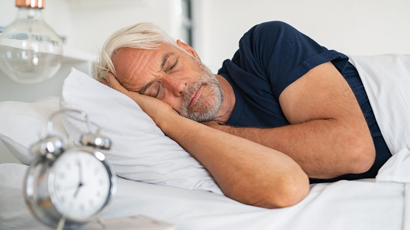 man sleeping in a bed