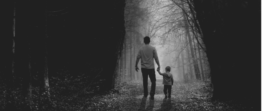 Father and son walking in the forest