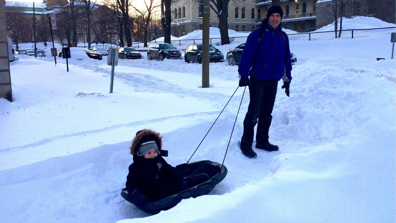 pulling Coop in a sled in the snow