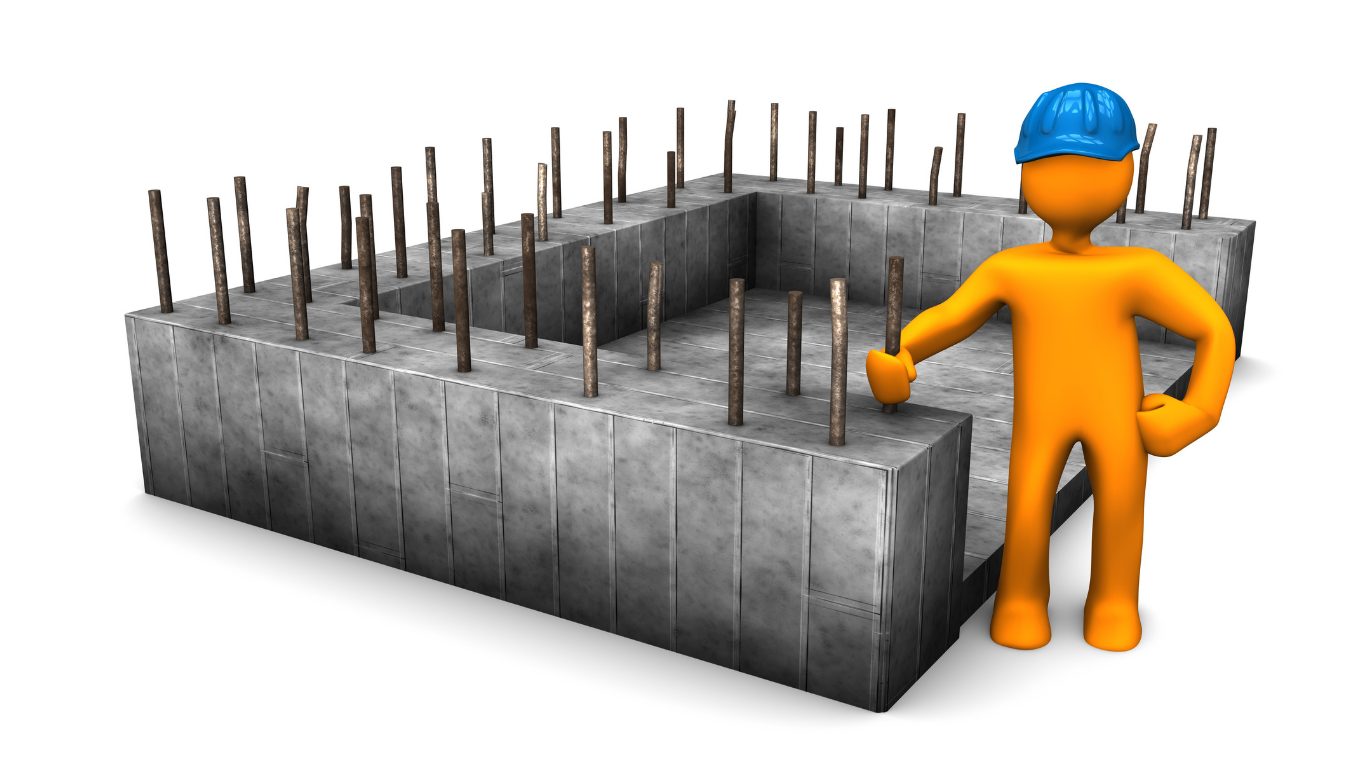 man next to concrete foundations