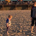 Standing on the beach with Coop looking at each other.