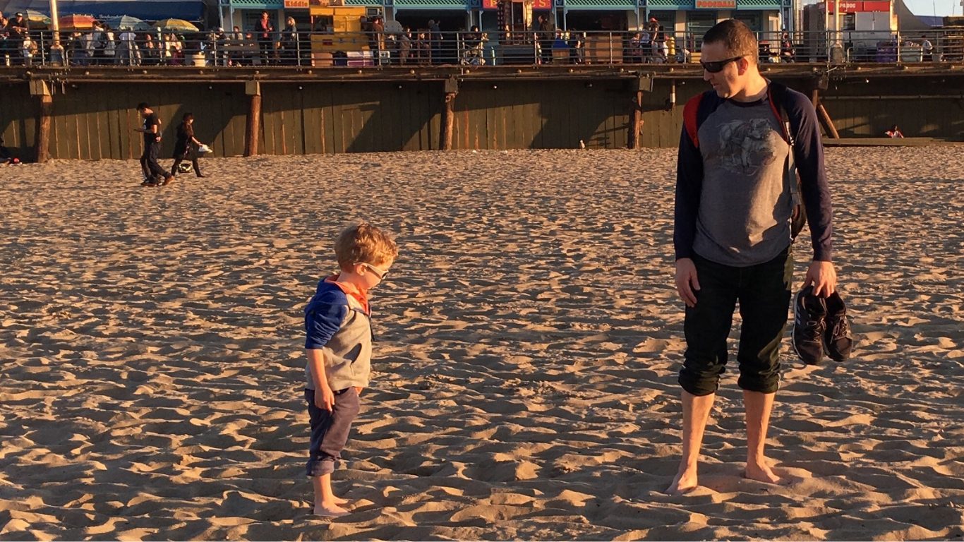 Standing on the beach with Coop looking at each other.