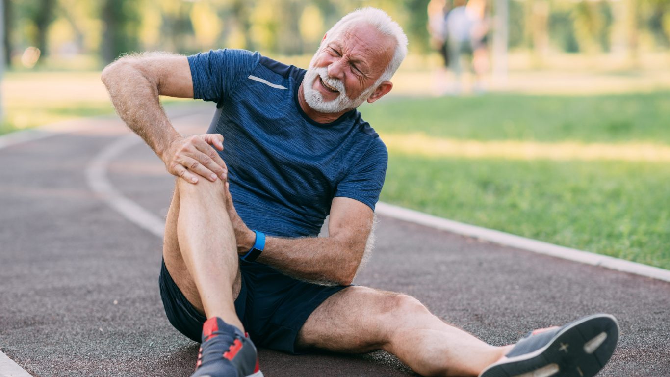old man holding his knee
