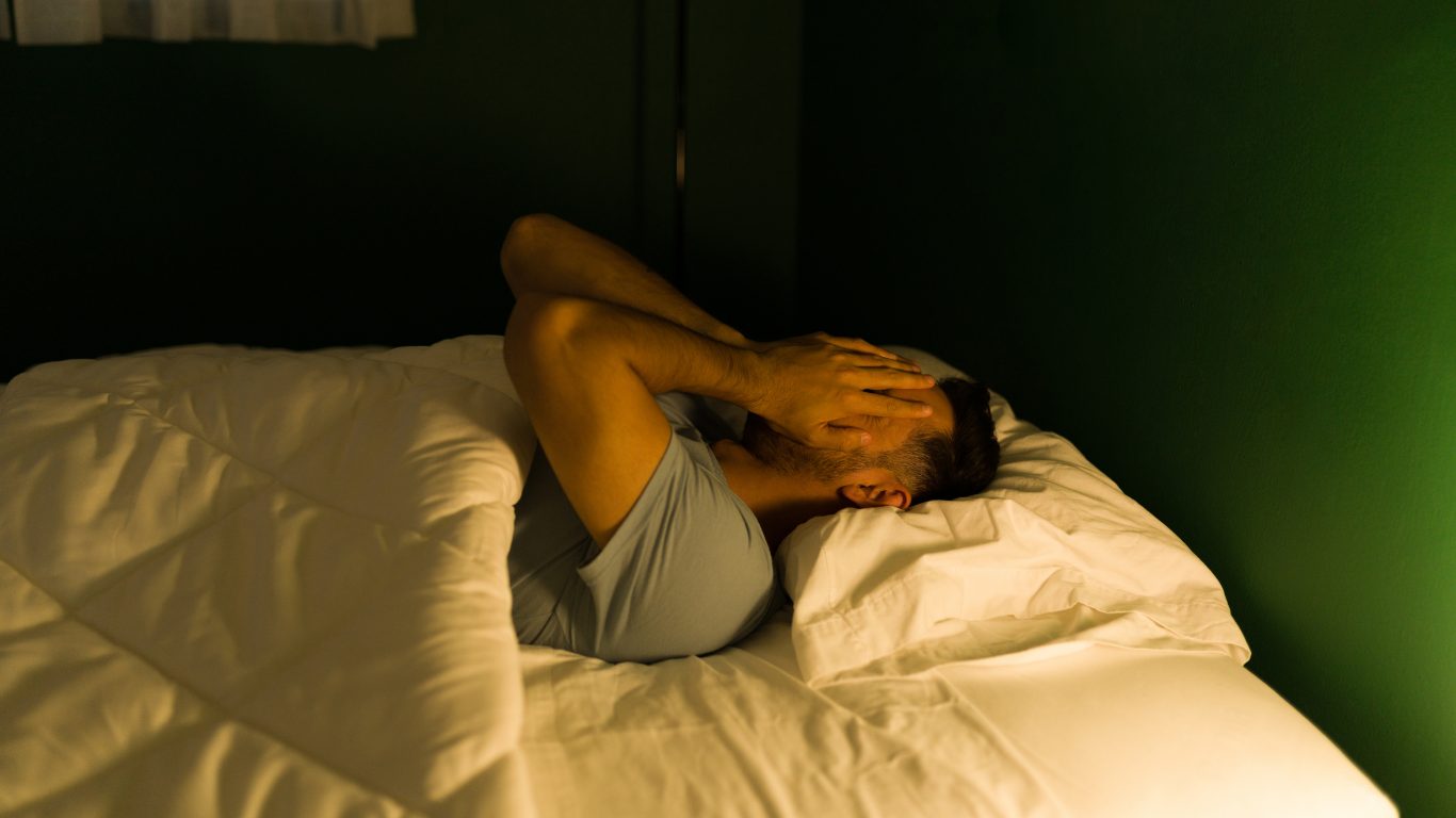 man sleeping in bed