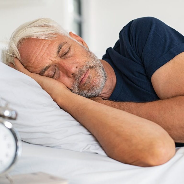 man sleeping in a bed