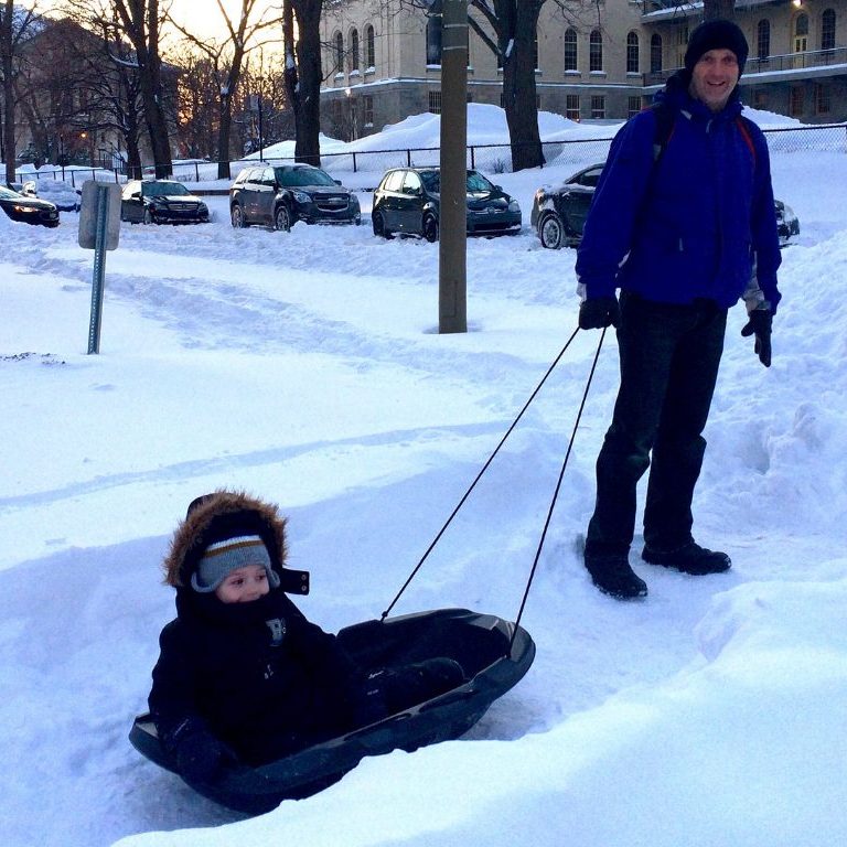 pulling Coop in a sled in the snow