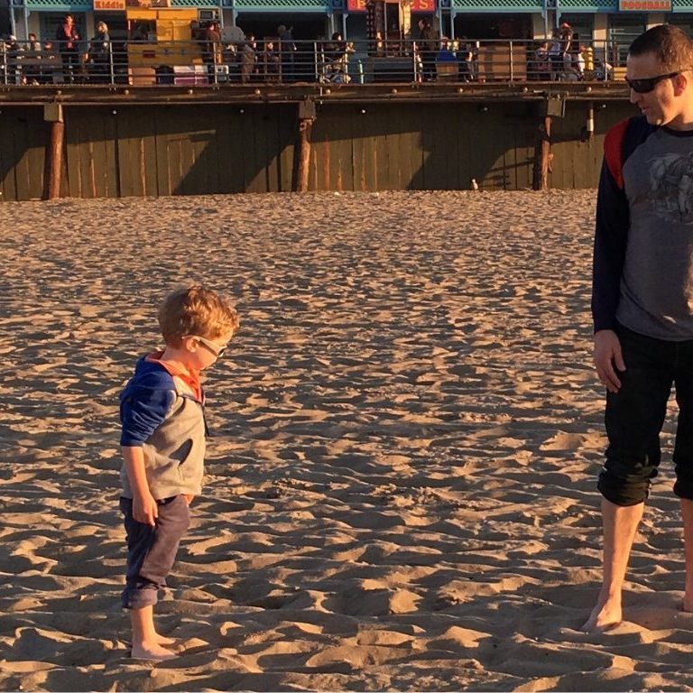 Standing on the beach with Coop looking at each other.