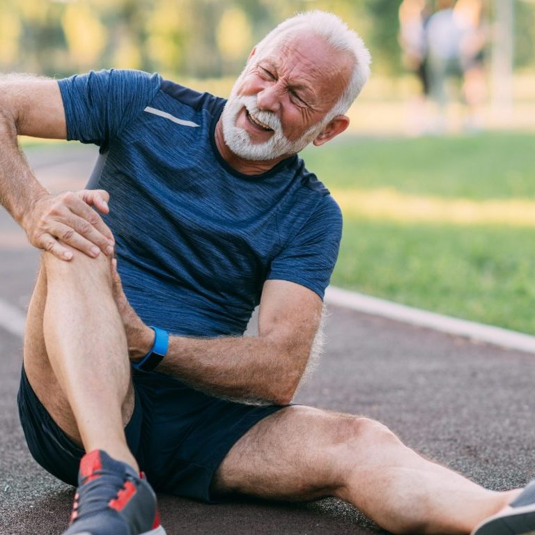 old man holding his knee