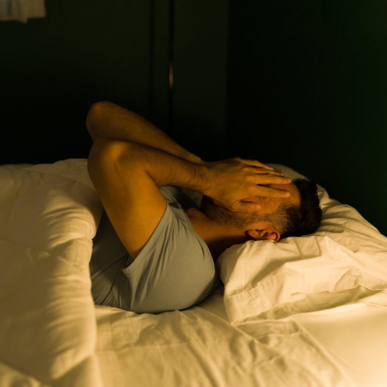man sleeping in bed